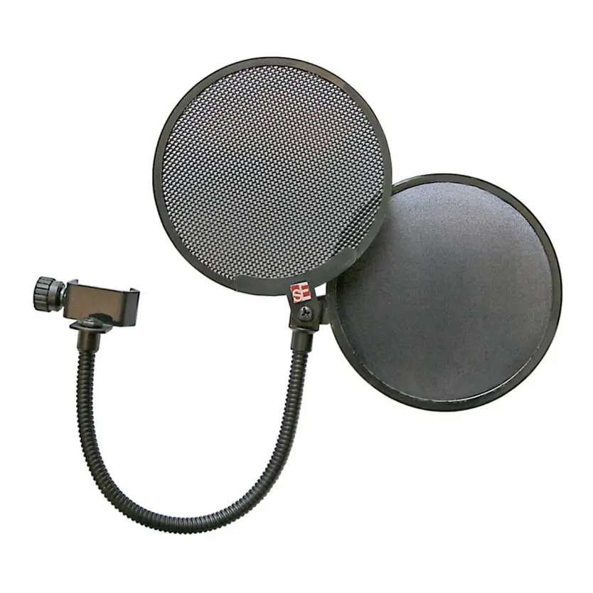 Person using a cheap microphone with a pop filter for recording.